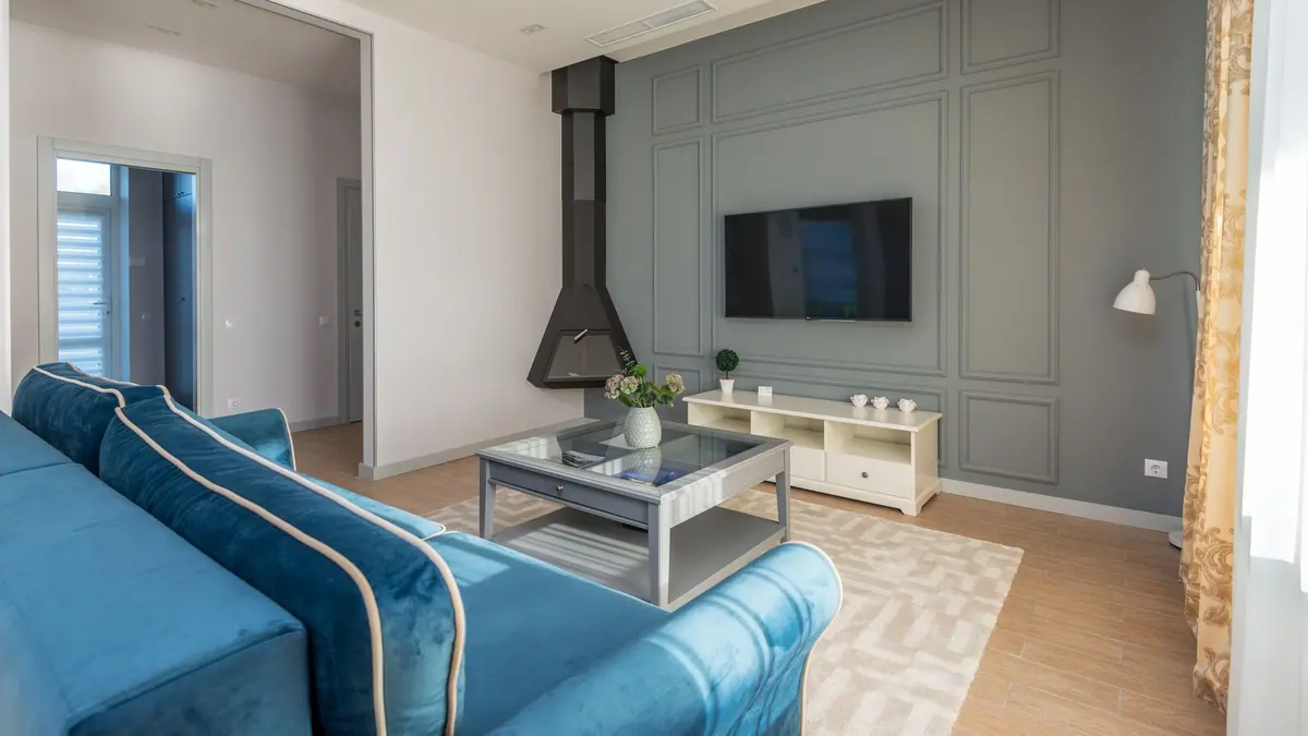 A television mounted on a wall in a lit living room