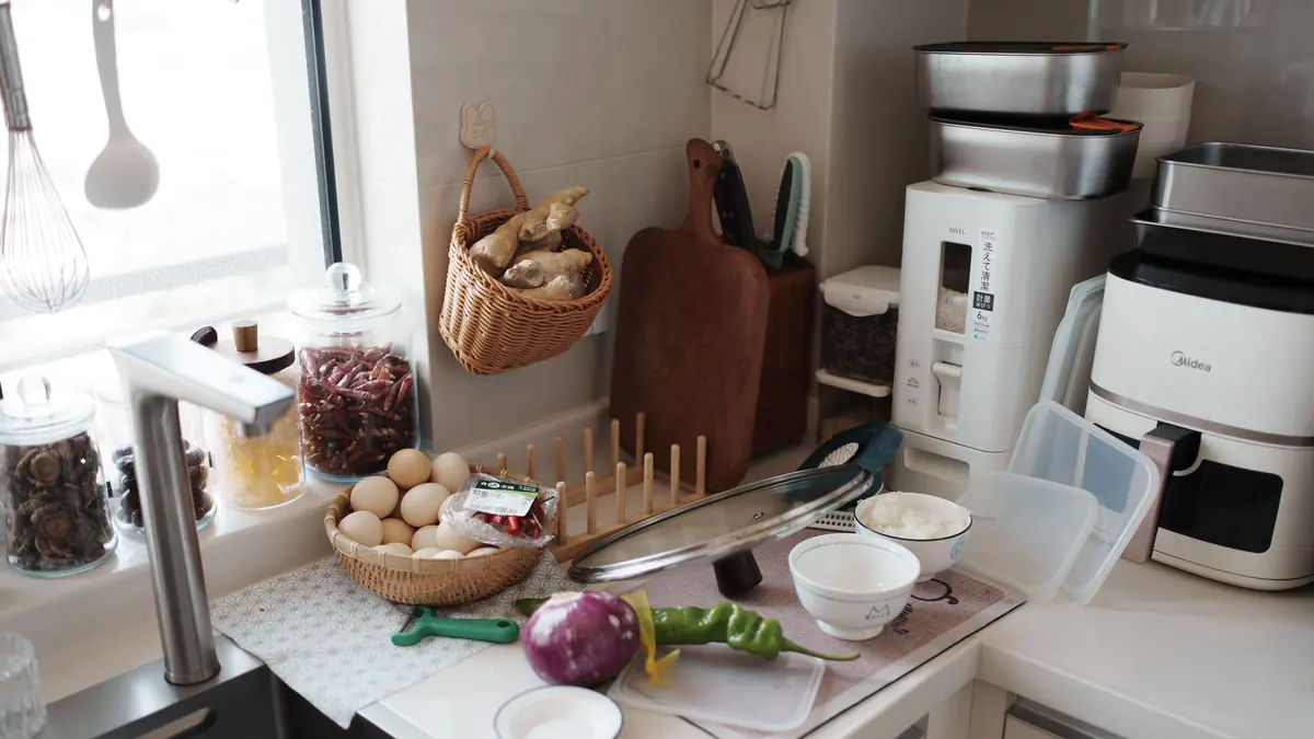 An air fryer on a kitchen worktop beside a chopping board