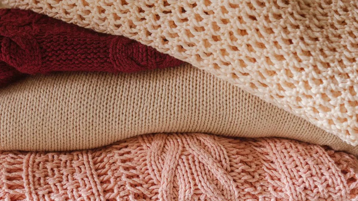 A folded merino base layer on a wooden surface