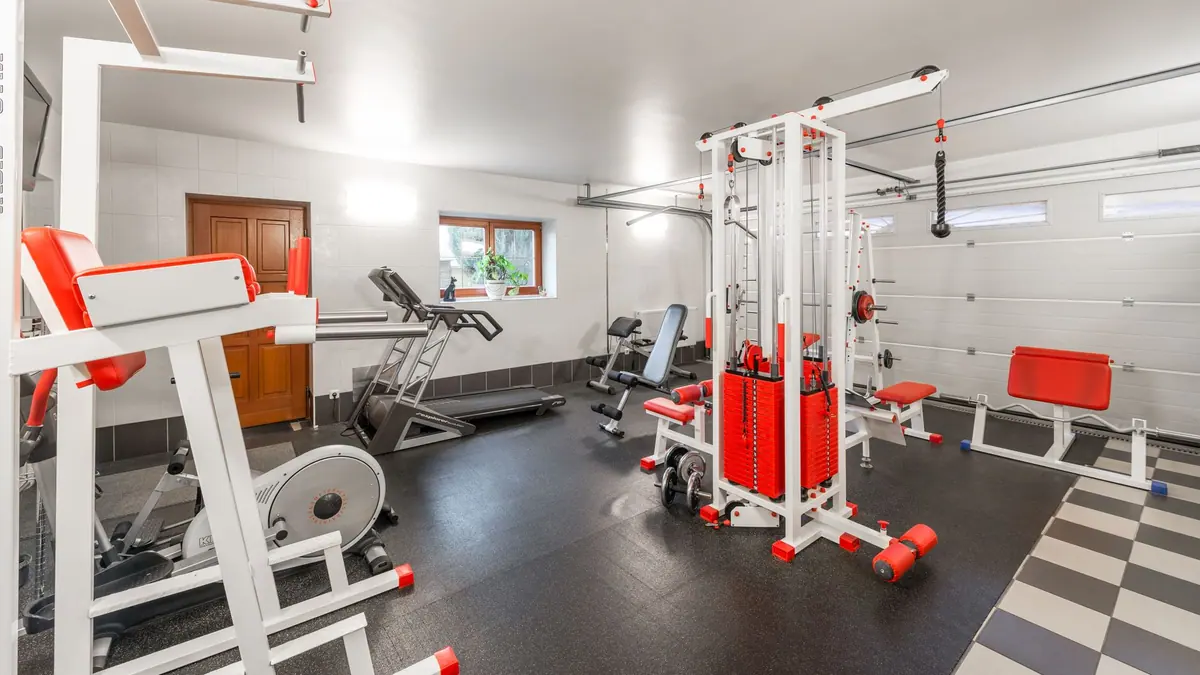 A treadmill in a home room beside a window