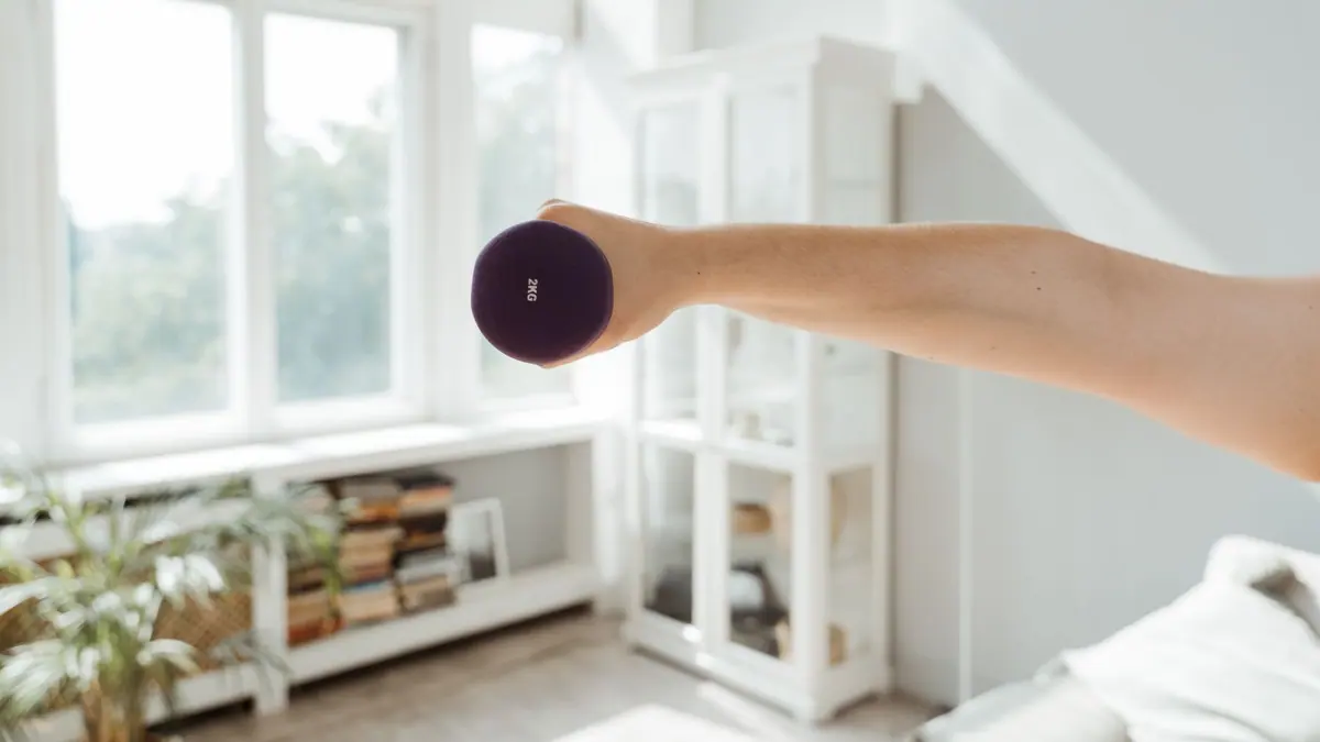 Dumbbells and a mat in the corner of a living room