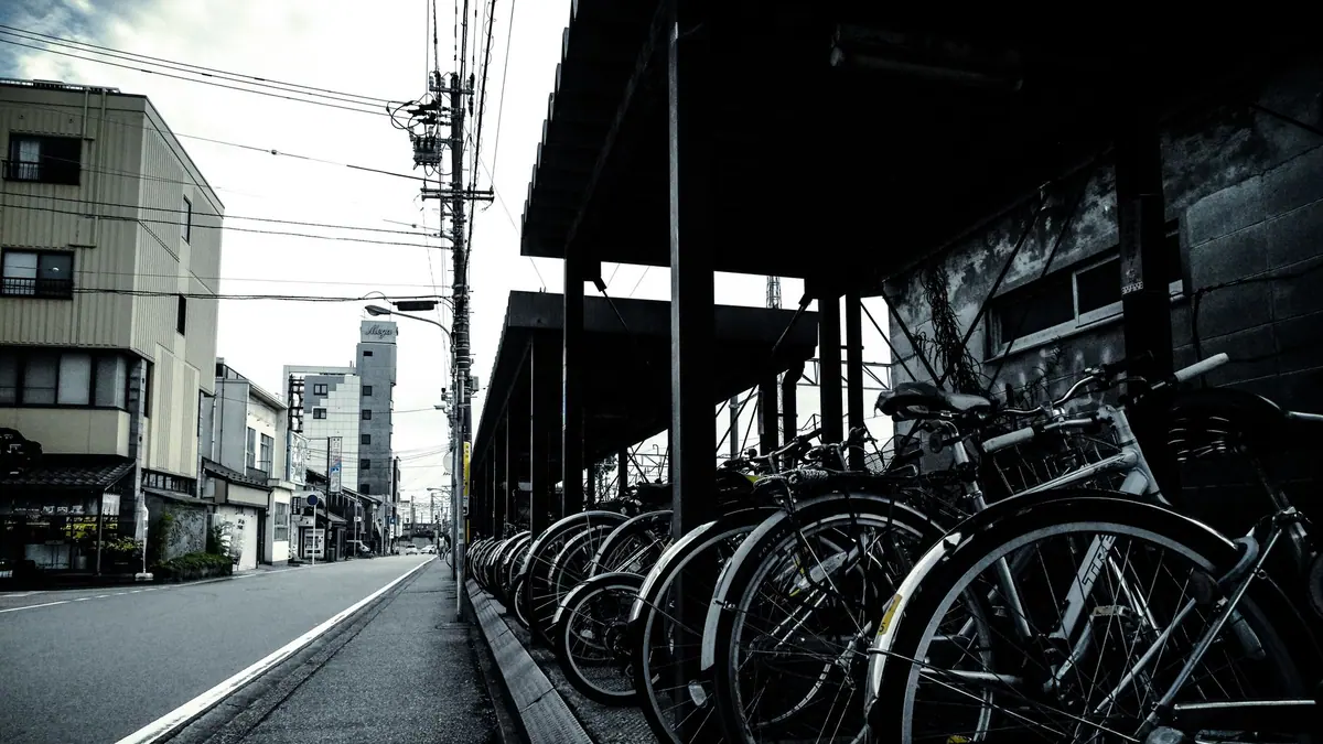 A bicycle leaning against a wall on a city street