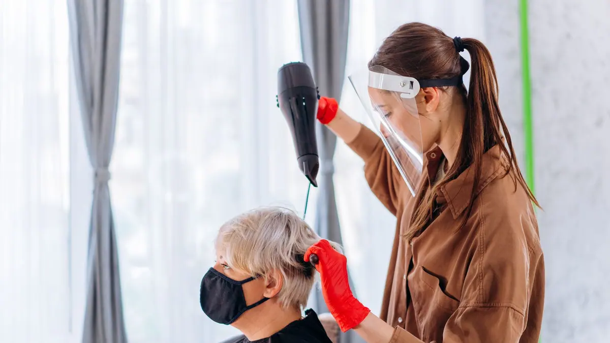 Someone drying their hair with a concentrator nozzle