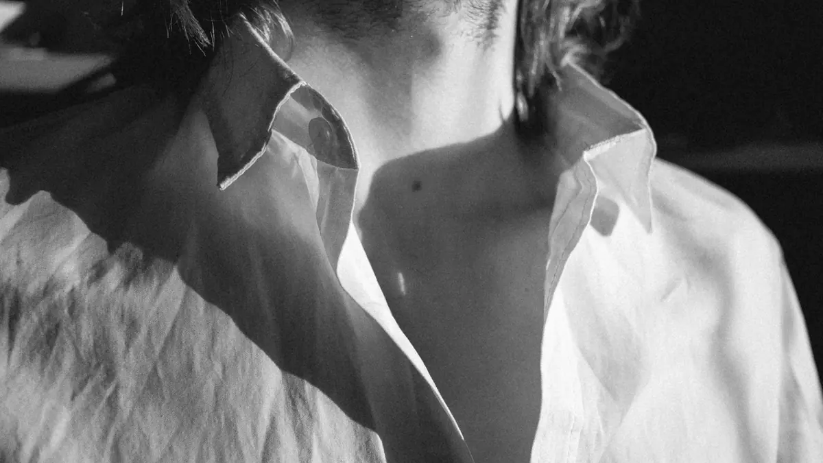 Close-up of a white shirt collar and top button