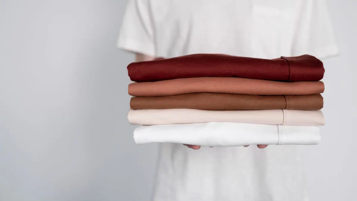 A stack of folded white shirts