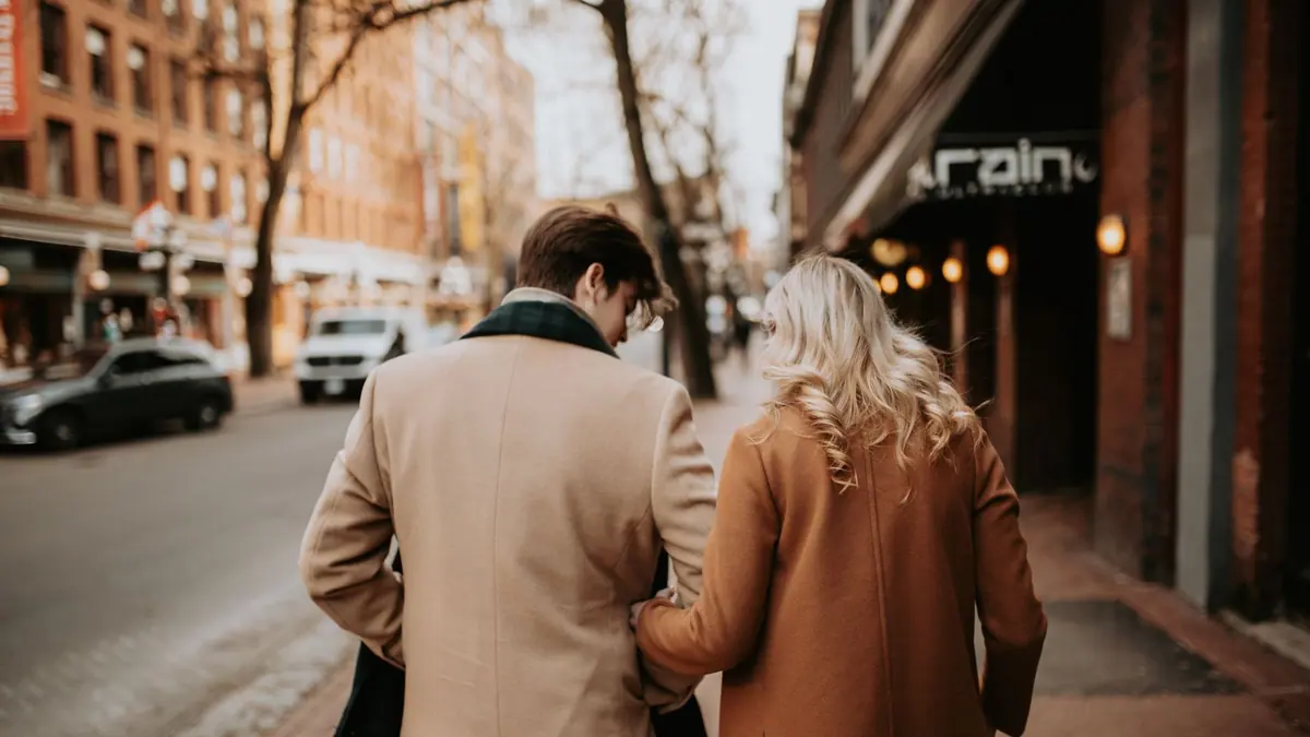 A person walking in a city wearing a warm coat