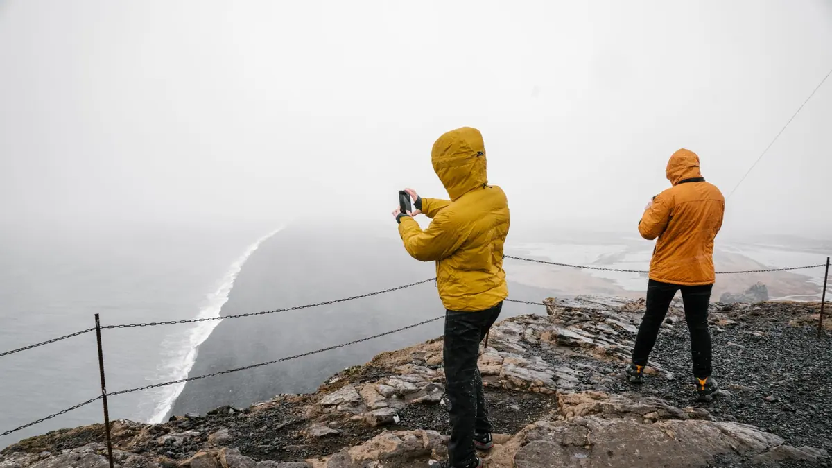 A hiker in a waterproof jacket in light rain