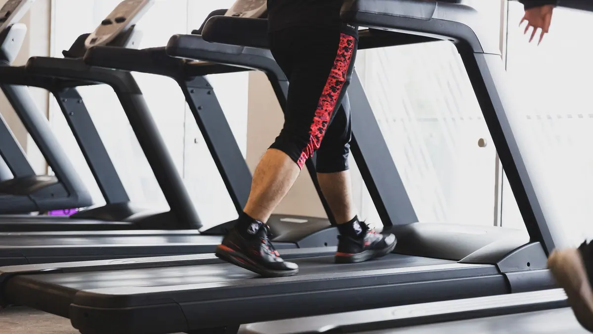 Running shoes beside a treadmill