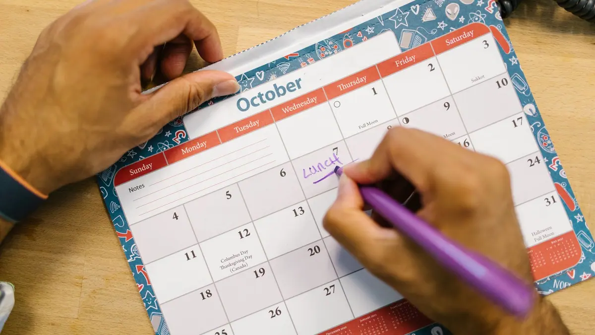A calendar and paperwork on a desk