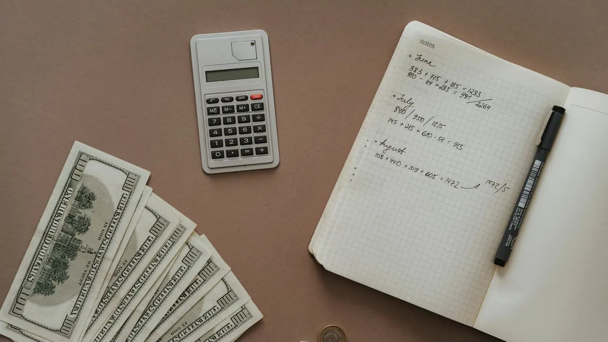 A notebook with a savings plan and a calculator