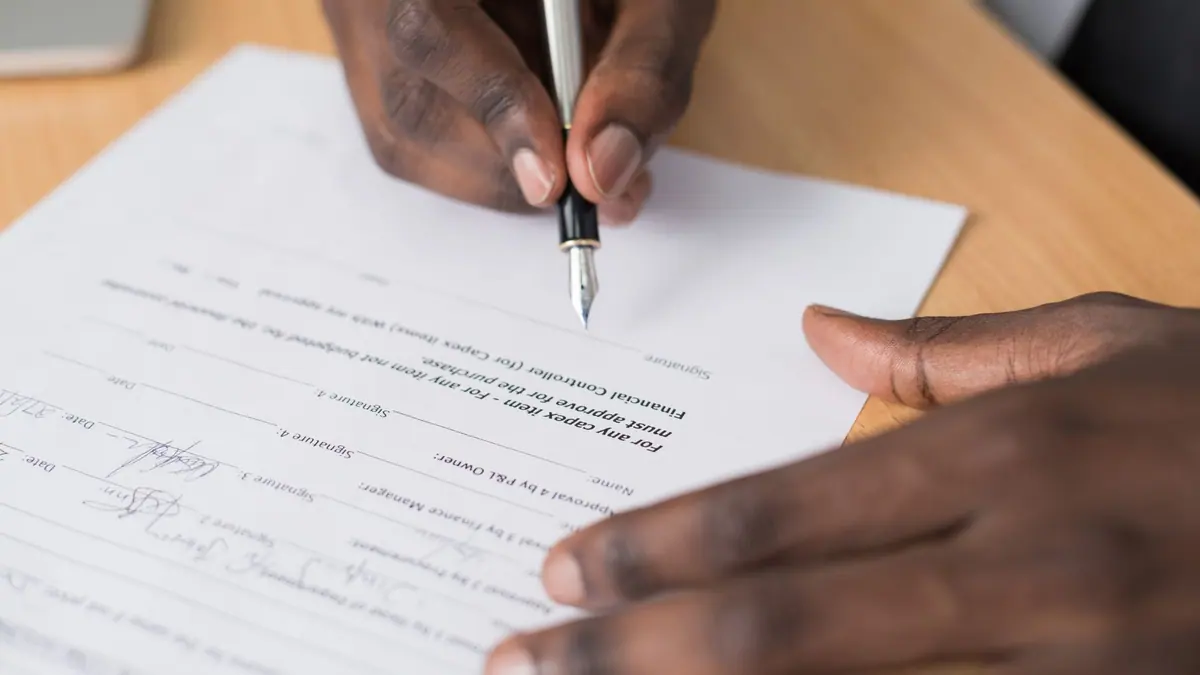 A person reading a document with a pen