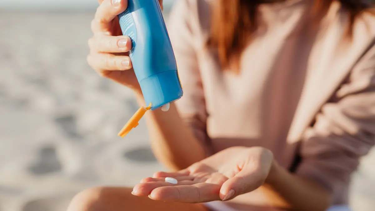 Sunscreen being applied to the back of a hand