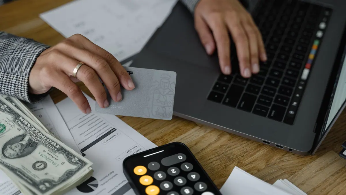 A calculator and notepad with figures